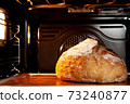 Baking sourdough bread in an oven. 73240877