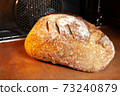 Baking sourdough bread in an oven. 73240879