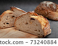 Sliced sourdough bread on dark cement background. 73240884