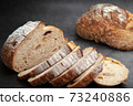 Sliced sourdough bread on dark cement background. 73240886