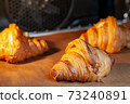 Baking croissants in an oven. 73240891