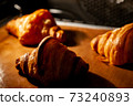 Baking croissants in an oven. 73240893