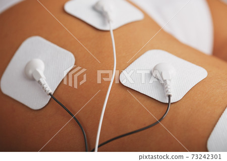 Myostimulation electrodes on the buttocks and legs of a woman in a beauty salon. Myostimulation electrodes on the buttocks and legs of a woman in a beauty salon. 73242301