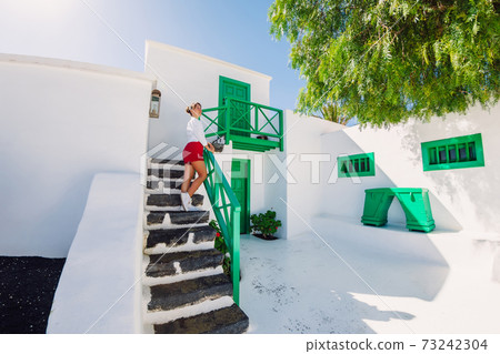 Traveller young woman posing with the historic architecture in Lanzarote 73242304