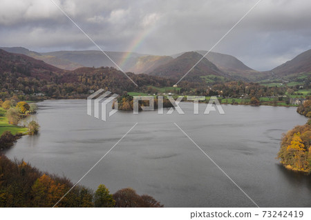 View from Loughrigg Fell over Grasmere with rainbow over fells, Lake District View from Loughrigg Fell over Grasmere with rainbow over fells, Lake District 73242419