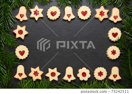 christmas cookies chocolate stars with raspberry crunches on slate table 73242511
