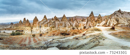 Landscape view of Unesco World Heritage, Cappadocia, Turkey under cloudy sky 73243301