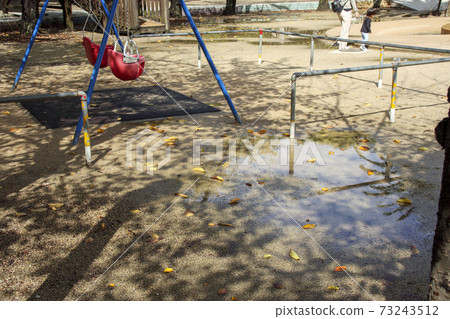 Playground equipment in the park after it rains Playground equipment in the park after it rains 73243512