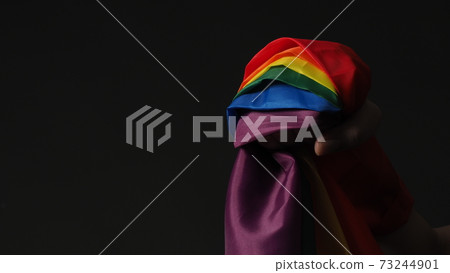 LGBTQ flag or Lesbian Gay Bi sexsual Transgender Queer or homosexsual pride Rainbow flag on black background. Represent hand symbol of freedom, peace, equality and love. LGBTQ concept LGBTQ flag or Lesbian Gay Bi sexsual Transgender Queer or homosexsual pride Rainbow flag on black background. Represent hand symbol of freedom, peace, equality and love. LGBTQ concept 73244901