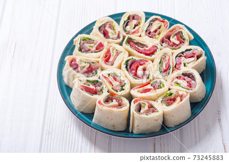 Sliced sandwich tortilla with vegetables and ham 73245883