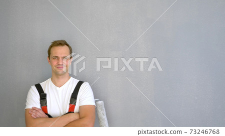 Copy space. portrait of a handsome man with a roller to paint the walls Copy space. portrait of a handsome man with a roller to paint the walls 73246768