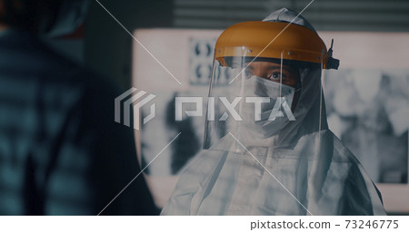 Black doctor speaking with colleague during work Black doctor speaking with colleague during work 73246775