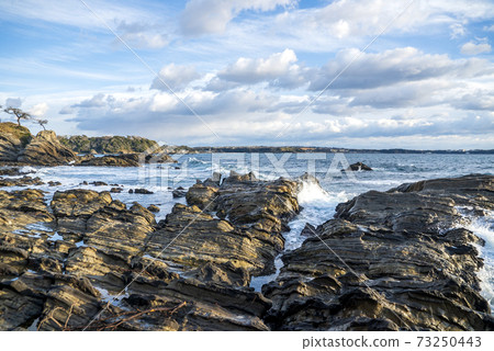 Arasaki coast in winter, sea, sky, clouds, waves, rock paddles and strong winds Arasaki coast in winter, sea, sky, clouds, waves, rock paddles and strong winds 73250443