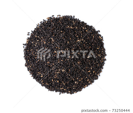 black sesame seeds on white background. Top view black sesame seeds on white background. Top view 73250444