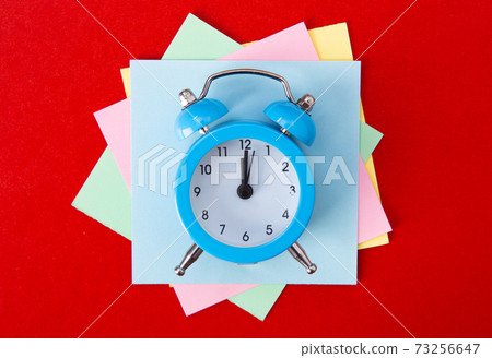 Alarm clock on red background. 73256647