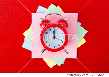 Alarm clock on red background. Alarm clock on red background. 73256648