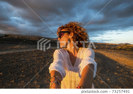 Joyful happy young adult woman play holding hands and turing having fun and laughing in outdoor leisure activity sith sunset golden light - concept of people having fun outdoor Joyful happy young adult woman play holding hands and turing having fun and laughing in outdoor leisure activity sith sunset golden light - concept of people having fun outdoor 73257491