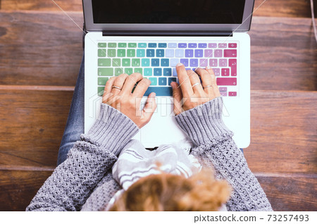 Top view of female caucasian hands working on coloured keyboard of laptop computer - concept of connected people and smart worrking with home technology internet connection 73257493