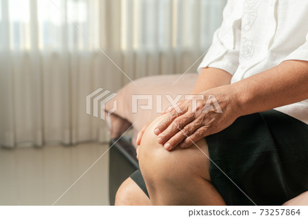 senior woman suffering from knee pain at home, health problem concept senior woman suffering from knee pain at home, health problem concept 73257864