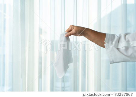 Senior women hand holding napkin/tissue paper 73257867