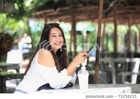 woman relax outdoor use smartphone 73258255