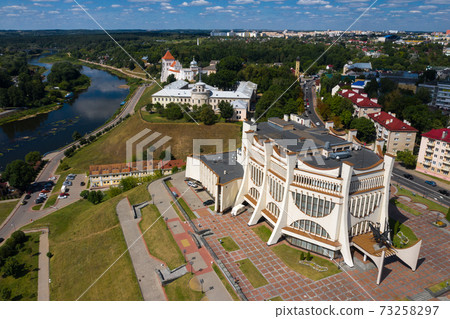 Top view of the city center of Grodno and the white Opera house, Belarus. The historic center of the city with a red tile roof, a castle and an Opera house. Top view of the city center of Grodno and the white Opera house, Belarus. The historic center of the city with a red tile roof, a castle and an Opera house. 73258297