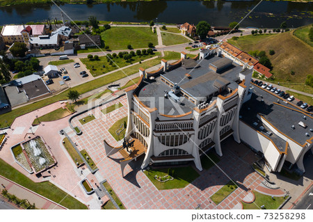 Top view of the city center of Grodno and the white Opera house, Belarus. The historic center of the city with a red tile roof, a castle and an Opera house. Top view of the city center of Grodno and the white Opera house, Belarus. The historic center of the city with a red tile roof, a castle and an Opera house. 73258298