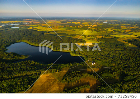 Top view of Bolta lake in the forest in the Braslav lakes National Park at dawn, the most beautiful places in Belarus.An island in the lake.Belarus. 73258456