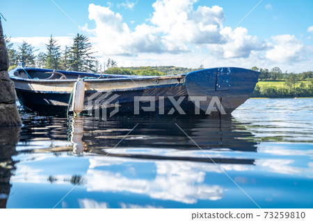 Rowing boat at the pier in Bruckless in County Donegal - Ireland. Rowing boat at the pier in Bruckless in County Donegal - Ireland. 73259810
