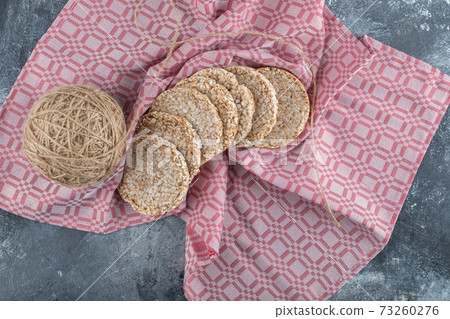 Rice waffles with a ball of yarn on a tablecloth Rice waffles with a ball of yarn on a tablecloth 73260276