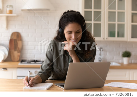 Smiling millennial woman watch webinar on laptop 73260813