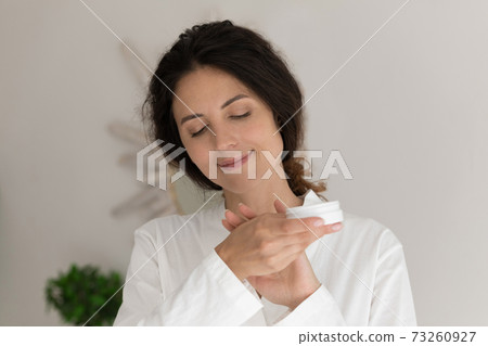 Young woman apply hand cream for healthy skin Young woman apply hand cream for healthy skin 73260927