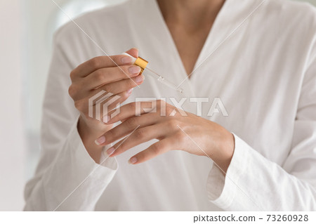 Close up of woman apply hand oil for healthy skin Close up of woman apply hand oil for healthy skin 73260928
