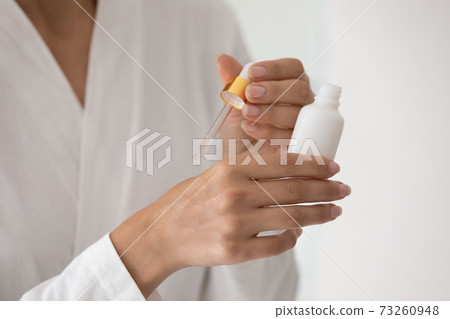 Close up of woman apply serum on hands skin Close up of woman apply serum on hands skin 73260948