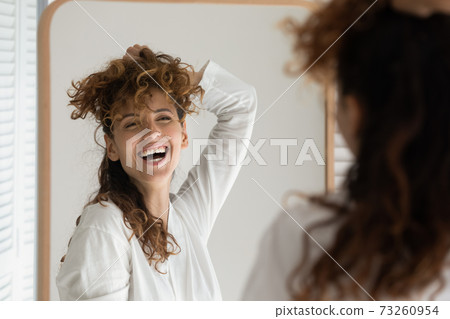 Smiling woman experiment with hairstyle in bath Smiling woman experiment with hairstyle in bath 73260954