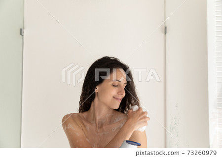 Happy woman wash in bathroom with foamy gel Happy woman wash in bathroom with foamy gel 73260979