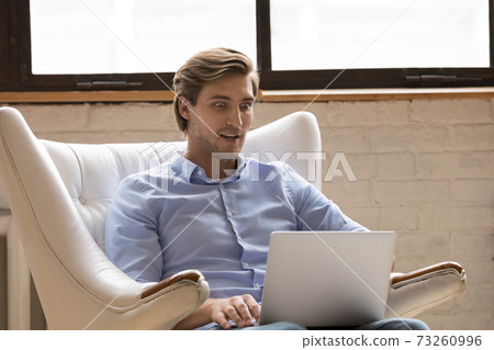 Stunned man shocked by news on laptop Stunned man shocked by news on laptop 73260996