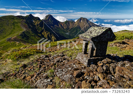 Stone shrine on the summit of Mt. Iodake and the main peaks of Yatsugatake in early summer Stone shrine on the summit of Mt. Iodake and the main peaks of Yatsugatake in early summer 73263243