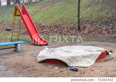 Children Playground with Covered Sandbox and Abandoned Toys 73263402