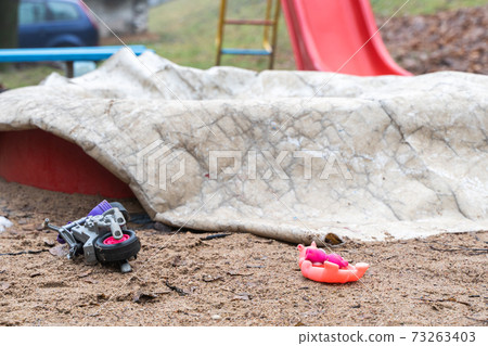 Children Playground with Covered Sandbox and Abandoned Toys Children Playground with Covered Sandbox and Abandoned Toys 73263403