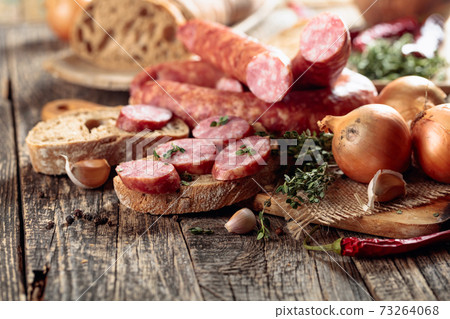 Dry-cured sausages with herbs and spices. 73264068