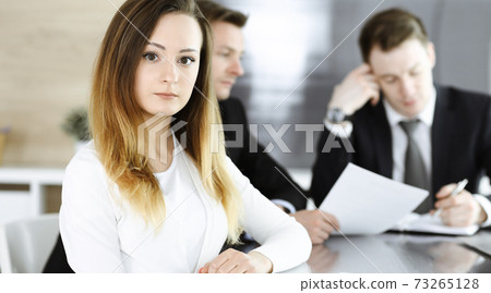 Business woman headshot at workplace in modern office. Unknown businesswoman sitting behind computer monitor. Young accountant or secretary looks good Business woman headshot at workplace in modern office. Unknown businesswoman sitting behind computer monitor. Young accountant or secretary looks good 73265128