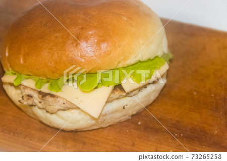 Fresh cheeseburger on wooden board Fresh cheeseburger on wooden board 73265258