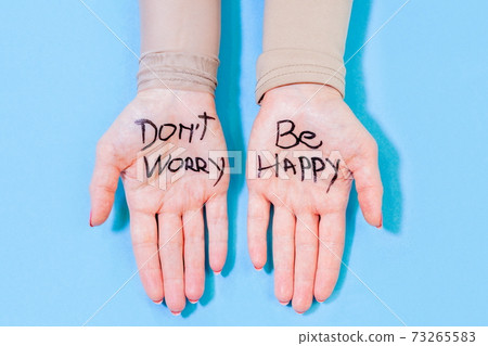 Don't worry be happy concept on woman hands Don't worry be happy concept on woman hands 73265583