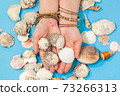 Woman holding shells in her hands 73266313