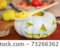 Carved Halloween pumpkin head on table 73266362