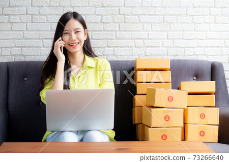 Young asian woman is entrepreneur talking with customer and using laptop computer while order. Young asian woman is entrepreneur talking with customer and using laptop computer while order. 73266640