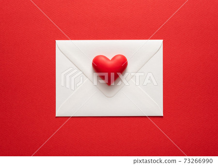 Minimalist valentines day card in red colors with heart on white envelope Minimalist valentines day card in red colors with heart on white envelope 73266990