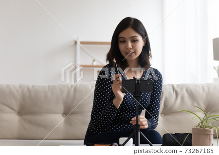 Attractive millennial vietnamese asian blogger recording advertising video. 73267185