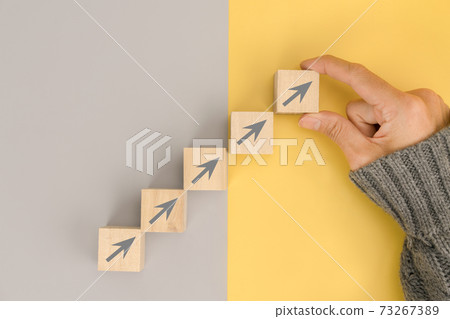 Woman hand arranging wood block for business growth and process for success 73267389